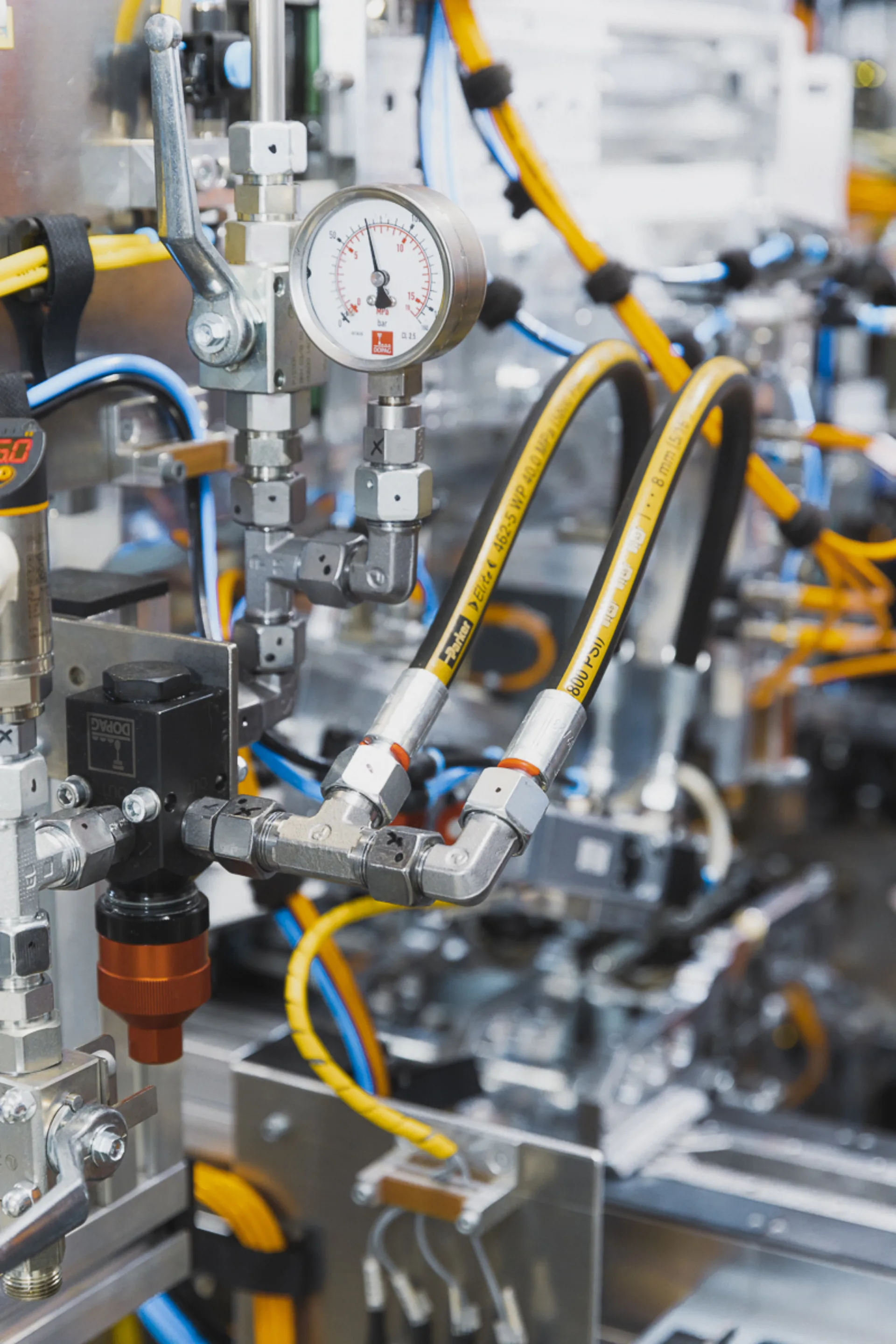 bunte Schläuche an Maschine montiert, Messanzeige